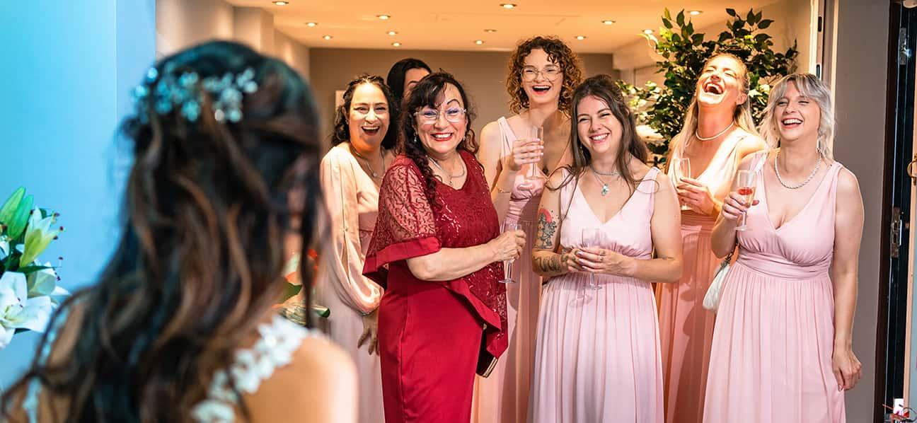 photo of bridesmaids laughing with mother of bride