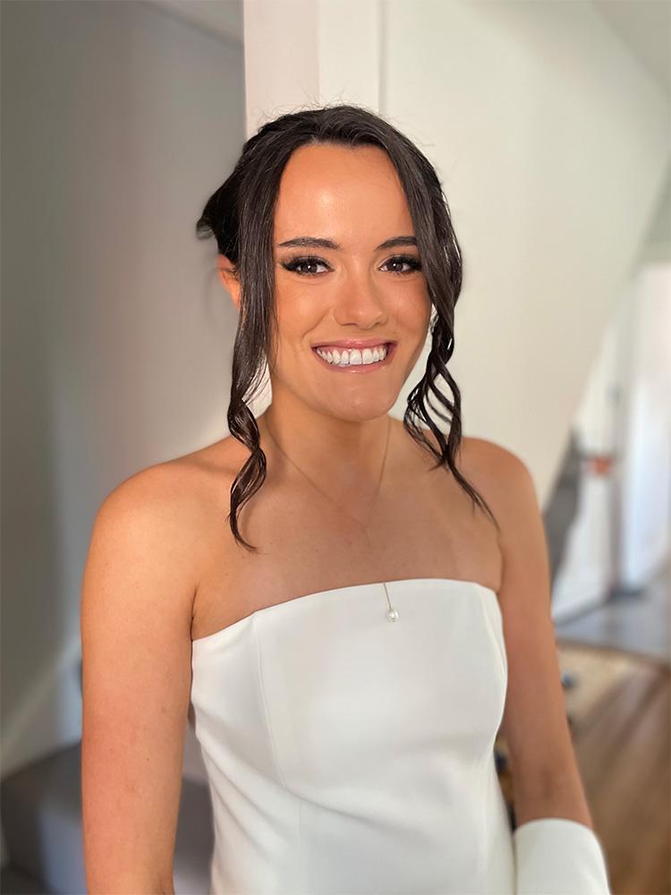 Bride smiling with finished bridal makeup look